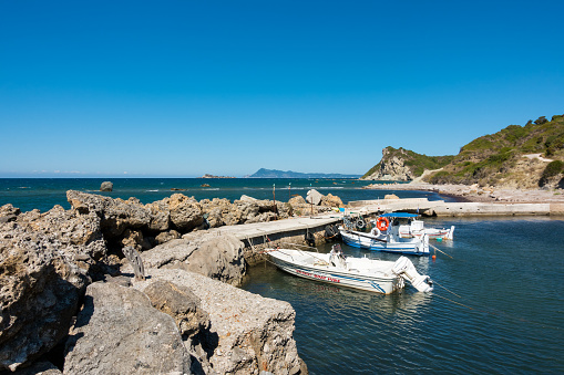 September 13th 2022 - Mathraki, Greece - Picturesque gulf with a small dock in Mathraki island, Greece