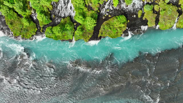 Waterfall in Iceland, Cold turquoise glacial river with many streams in summer season, Epic aerial landscape.