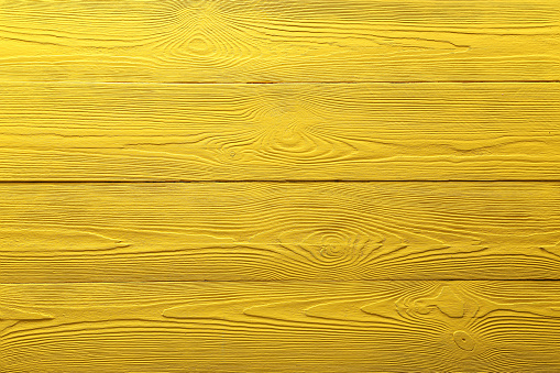 Texture of yellow wooden surface as background, top view
