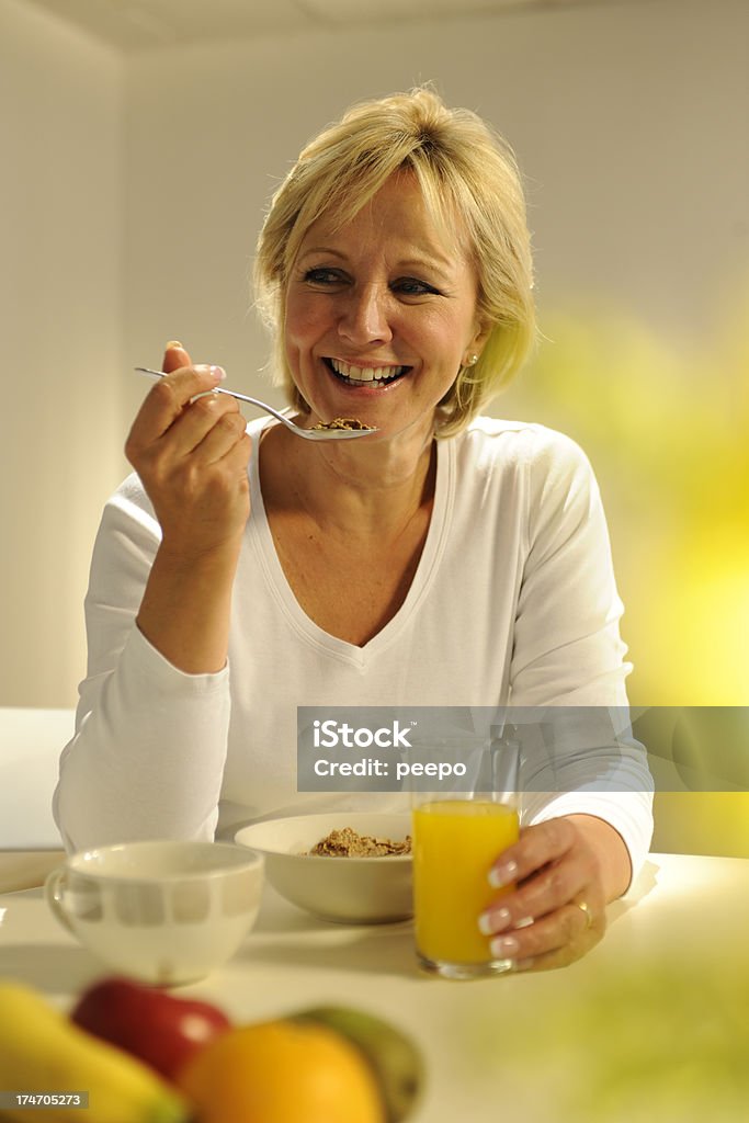 Mature Woman Eating Breakfast 50-54 Years Stock Photo