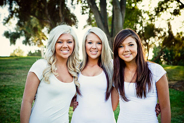 three sisters standing portrait at the park