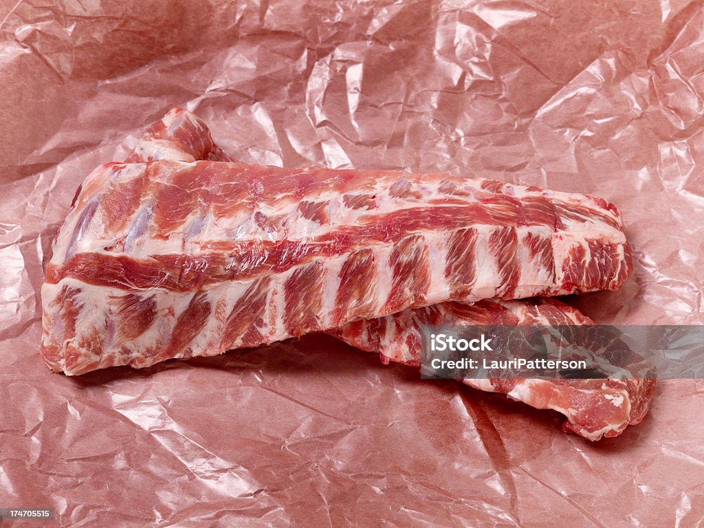 Raw Baby Back Pork Ribs in Butcher Paper "Raw Baby Back Pork Ribs Seasoned with Salt and Pepper in Butcher Paper, Ready for the Grill.-Photographed on Hasselblad H3D2-39mb Camera" Beef Stock Photo