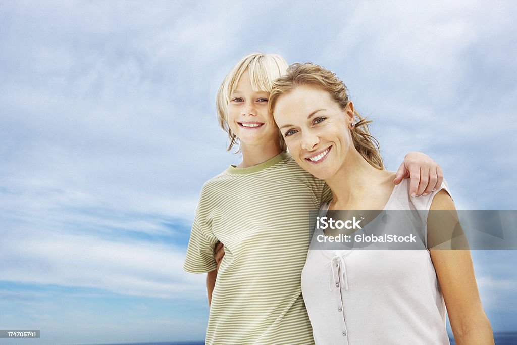 Portrait of a mother and son smiling Portrait of a mother and son smiling with their arm 20-24 Years Stock Photo