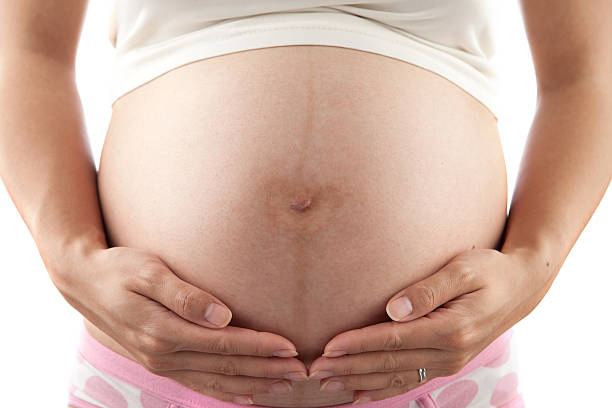 istock pregnant woman holding her belly 174706197