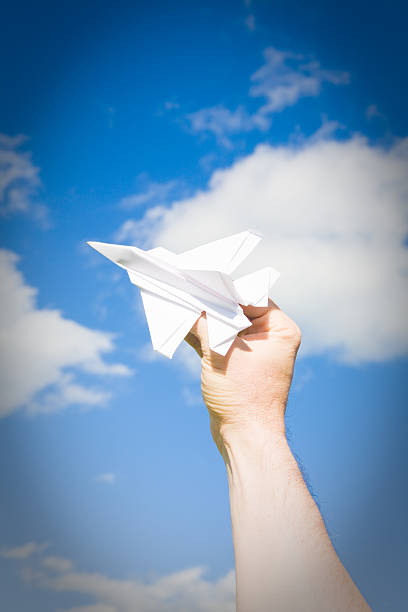 istock Origami Paper Airplane Flying Outside Blue Sky 174706230