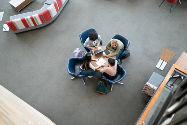 istock Overhead view of university students working on round table 1747087807