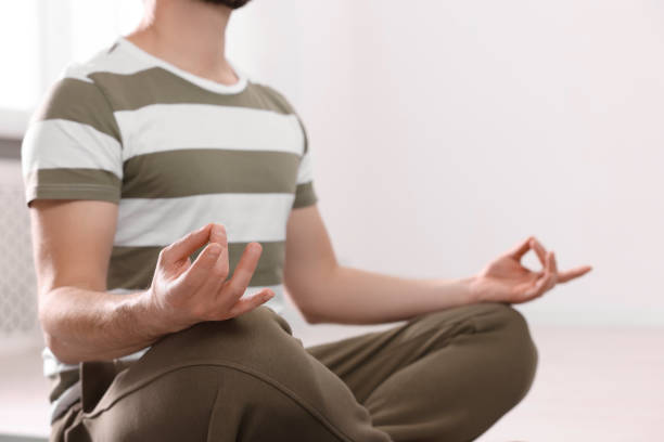 istock Closeup view of man meditating indoors, space for text 1747093227