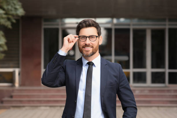 istock Handsome real estate agent in nice suit outdoors 1747096507