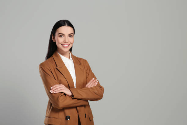 istock Beautiful real estate agent in nice suit on grey background, space for text 1747099170
