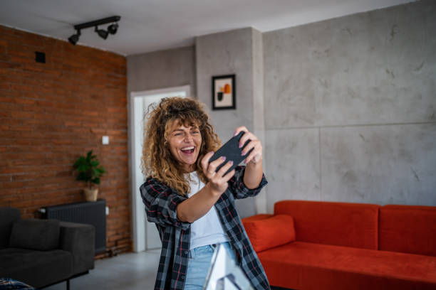 istock A young woman is holding a mobile phone and using mobile banking, she is happy because her bank account balance has increased 1747102031