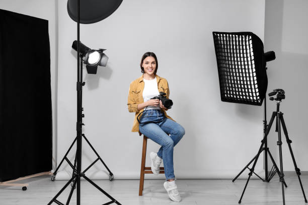 istock Professional photographer with camera in modern photo studio 1747105460