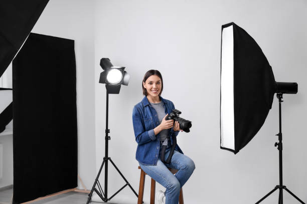 istock Professional photographer with camera in modern photo studio 1747105463