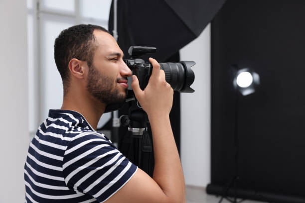 istock Young professional photographer taking picture in modern photo studio, space for text 1747106608