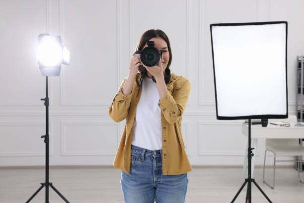 istock Professional photographer taking picture in modern photo studio 1747106615