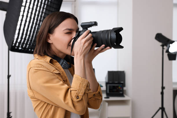 istock Professional photographer taking picture in modern photo studio 1747108218