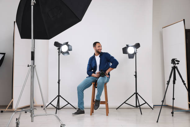 istock Young professional photographer with camera in modern photo studio 1747108220