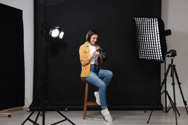 istock Professional photographer with camera in modern photo studio 1747108228