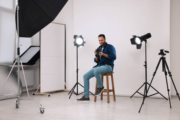 istock Young professional photographer with camera in modern photo studio 1747108752
