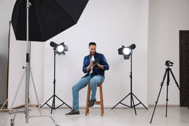 istock Young professional photographer with camera in modern photo studio 1747109272
