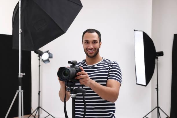 istock Young professional photographer with camera in modern photo studio 1747112614