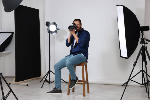 istock Young professional photographer taking picture in modern photo studio 1747113149