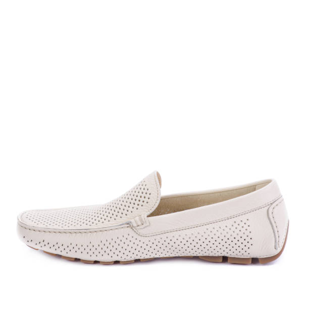 istock Modern ivory perforated leather men's moccasin shoe isolated on a white background with copy space. Creative minimalistic layout with footwear. Shoe store advertisement. 1747118634
