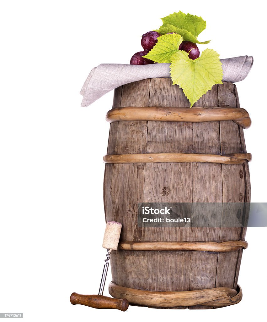 grapes on a wooden vintage barrel with corkscrew Ripe grapes on a wooden vintage barrel with corkscrew isolated on a white background Alcohol Abuse Stock Photo