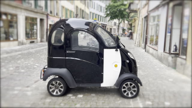 Compact European Transportation - One-Person Mini Electric Car Parked on Street