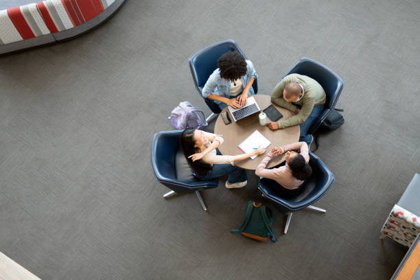 istock Overhead view of university students working on round table 1747163533