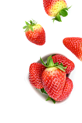 raw strawberries on white background.
