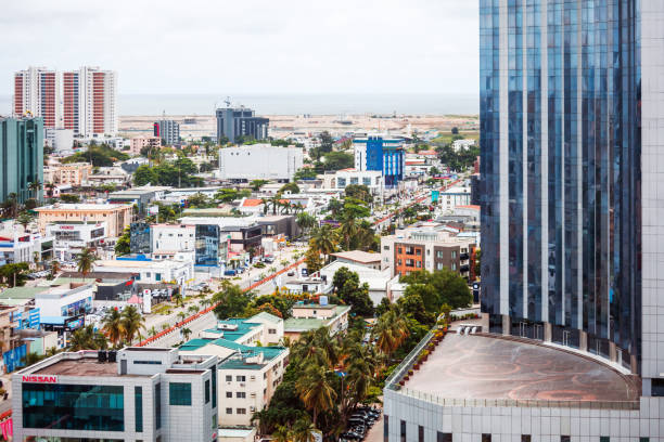 Kinshasa, Democratic Republic of Congo - March 29, 2023 : Yellow building on the city street in Kinshasa in The Democratic Republic of Congo.
