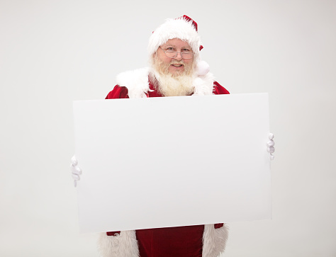 Santa Claus holding up a blank sign