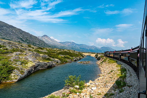 Near Llanberis, Gwynedd, Wales, UK - June 14, 2017: View from the Llanberis Path, looking north towards Llyn Padarn and Llanberis, with the Snowdon Mountain Railway and people sitting in the train