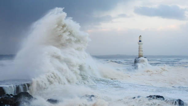 Storm waves striking the breakwater at Aberdeen Harbour Storm waves striking the breakwater at the harbour entrance in Aberdeen, Scotland, during Storm Babet north sea waves stock pictures, royalty-free photos & images