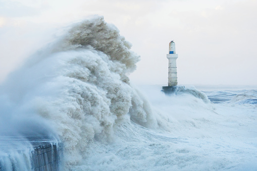 Storm waves striking the breakwater at the harbour entrance in Aberdeen, Scotland, during Storm Babet