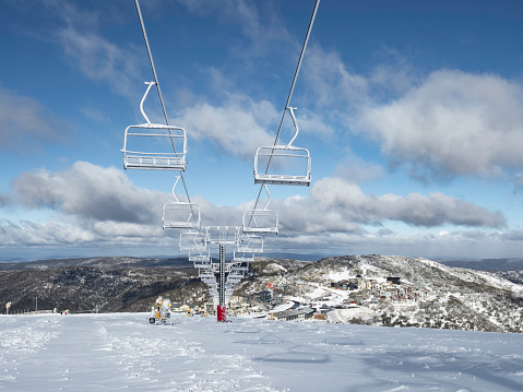 Empty still chair lift at Mount Hotham with early snow before the ski season starts
