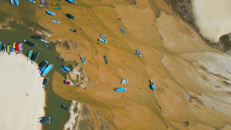 Small boats stranded in the nearly dry bed of the Tapajos river