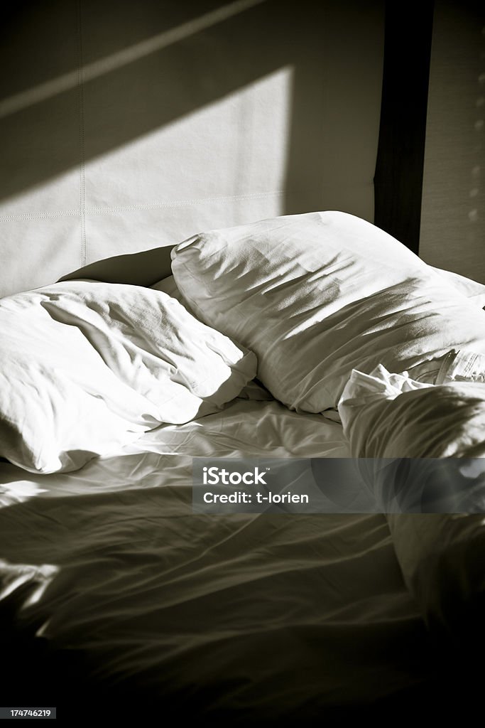 Without. Double bed leaving the sign of only one person. Messy Stock Photo