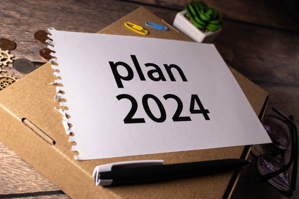 istock Paper plate, marker, diagram, chart and office tools. Text PLAN 2024 1747474158