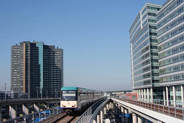 Photo of Subway train between office buildings