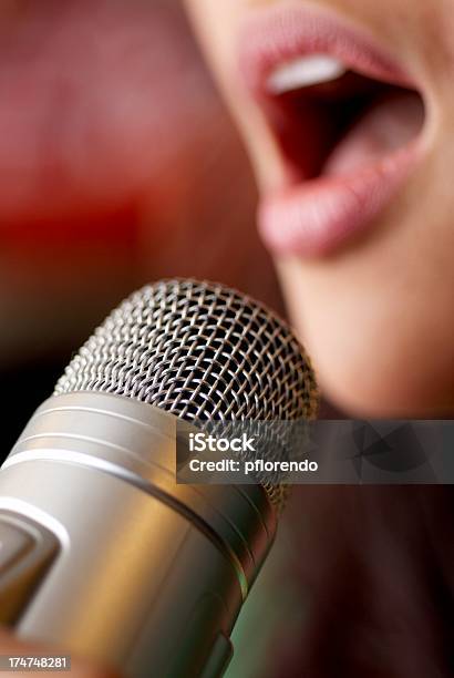 Closeup Of A Womans Mouth Singing Into A Silver Microphone Stock Photo - Download Image Now