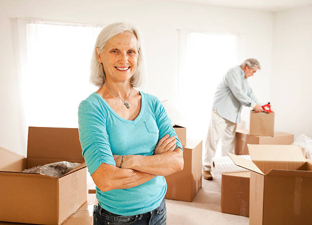 istock A senior couple filling up their boxes ready to move 174748336