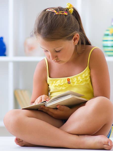 istock Little girl learning in living room 174748605