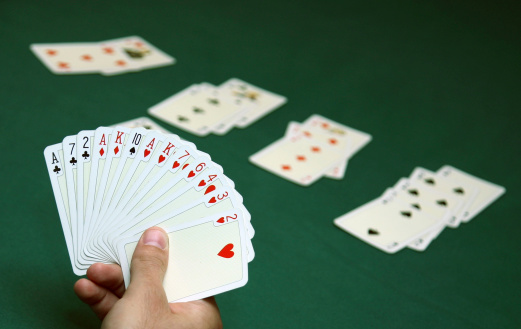 Hand holding cards ready to play bridge