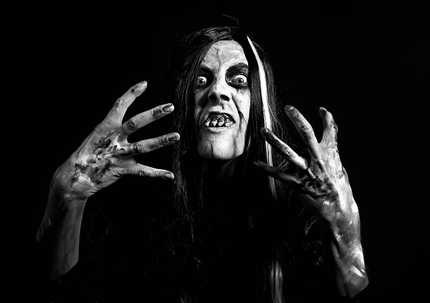 A black and white image of a creepy zombie dressed for Halloween.