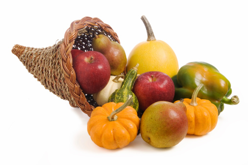 A cornucopia filled with autumn fruits and vegetables.