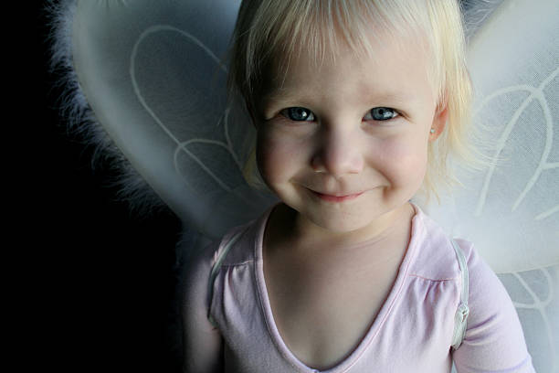 Little girl dressed as an angel stock photo