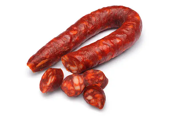 Sliced chorizo sausage isolated on white.