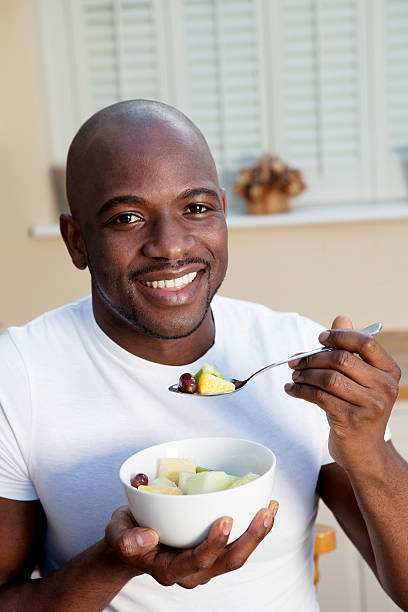 istock Young African man with great teeth eating healthily 174749823