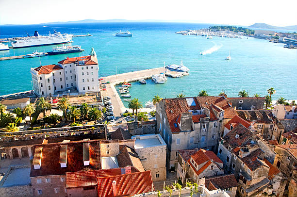 Cityscape of old town Split, Croatia "View of Split from the bell tower of the cathedral St Domnius. Visible are old town of Split, his historic buildings, sailing boats, Diocletian Palace, restaurants, Adriatic Sea, coffee bars, hotels and many palm trees. See more images like this in:" split croatia stock pictures, royalty-free photos & images